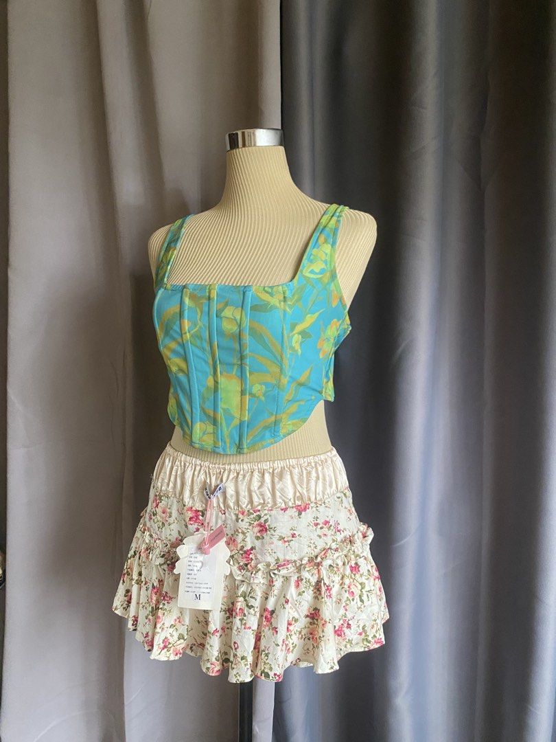 Luck & Trouble Teal Abstract Print Corset Top (Category: Sleeveless) located in Cagayan de Oro. Submitted by curated_closetph (Listing ID 1470745595, Image 2). Description: — Size: S - M — Color: Teal / Multicolored — Structured cotton-blend fabric with vibrant abstract pattern — Square neckline with wide tank-style shoulder straps — Vertical boning details along the bodice — Curved asymmetrical hem — Exposed back zipper closure — Can negotiate t