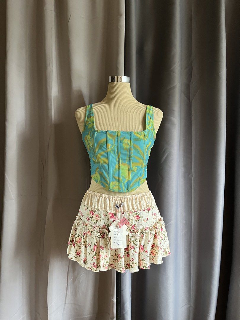 Luck & Trouble Teal Abstract Print Corset Top (Category: Sleeveless) located in Cagayan de Oro. Submitted by curated_closetph (Listing ID 1470745595, Image 1). Description: — Size: S - M — Color: Teal / Multicolored — Structured cotton-blend fabric with vibrant abstract pattern — Square neckline with wide tank-style shoulder straps — Vertical boning details along the bodice — Curved asymmetrical hem — Exposed back zipper closure — Can negotiate t