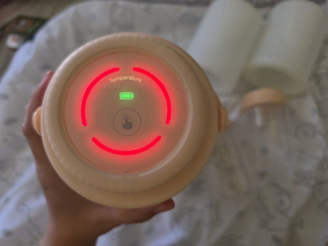 LUCKBEE Portable Milk Cooler Set with Bottles (Category: Breastfeeding & Bottle Feeding) located in Tagaytay City. Submitted by jjtaebear (Listing ID 1470747252, Image 2). Description: - Brand: LUCKBEE portable breastmilk cooler - Color: Pastel peach and cream gradient - Features: Digital temperature touch control display - Includes: 2 milk bottles (up to 240ml capacity with measurement markings), box - Accessories: Extra bottle caps and 2 white 