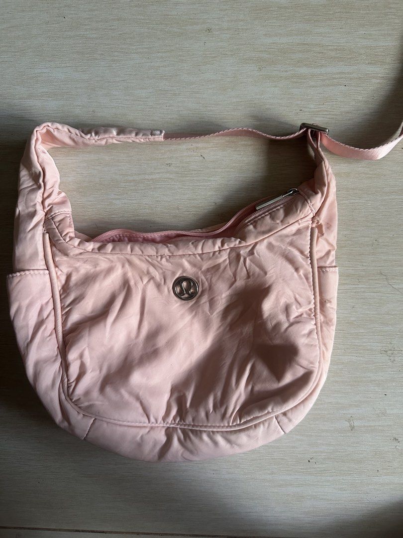 Lululemon Pink Shoulder Bag (Category: Shoulder Bags) located in Manila. Submitted by zayzay08 (Listing ID 1470788959, Image 1). Description: - Authentic Lululemon shoulder bag in light pink - Soft and stylish quilted material with metallic logo emblem - Secure zippered top closure and adjustable strap - Handy side slip pockets and smooth pink lining - Dimensions: 29 x 12 cm - Condition: Pristine, clean inside and out -issue need wash.