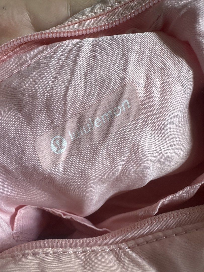 Lululemon Pink Shoulder Bag (Category: Shoulder Bags) located in Manila. Submitted by zayzay08 (Listing ID 1470788959, Image 3). Description: - Authentic Lululemon shoulder bag in light pink - Soft and stylish quilted material with metallic logo emblem - Secure zippered top closure and adjustable strap - Handy side slip pockets and smooth pink lining - Dimensions: 29 x 12 cm - Condition: Pristine, clean inside and out -issue need wash.