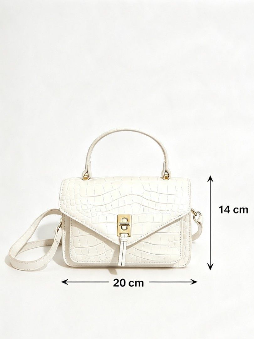 Luxury Unbranded Croc-Embossed Structured Leather Crossbody Bag (Category: Cross-body Bags) located in Naval. Submitted by ziphora.co (Listing ID 1470809870, Image 1). Description: High-quality, thick genuine leather bag in a timeless cream color. Features a beautiful crocodile-embossed finish and sturdy structured shape. Complete with a secure gold-tone turn-lock clasp, elegant top handle, and matching adjustable crossbody strap. Unbranded bouti