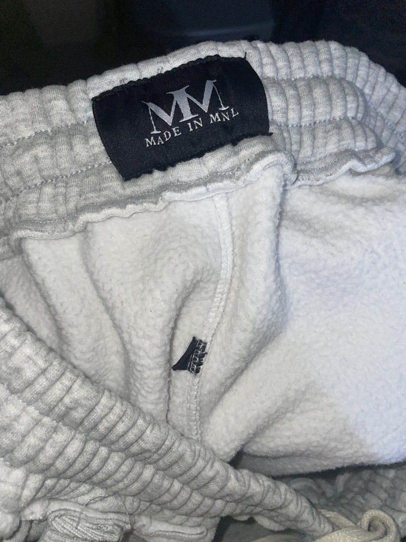 Made in MNL Grey Sweatpants -XL (Category: Joggers) located in Makati City. Submitted by oddbear_e25815 (Listing ID 1470916814, Image 1). Description: - Brand: Made in MNL -SIZE: XL - Color: Grey - Material: Soft fleece lining inside - Fit: Relaxed wide leg fit - Waistband: Elastic with a drawstring closure - Pockets: Deep front pockets - Details: Black brand tag stitched at the back waist - Condition: Clean, no stains or holes.