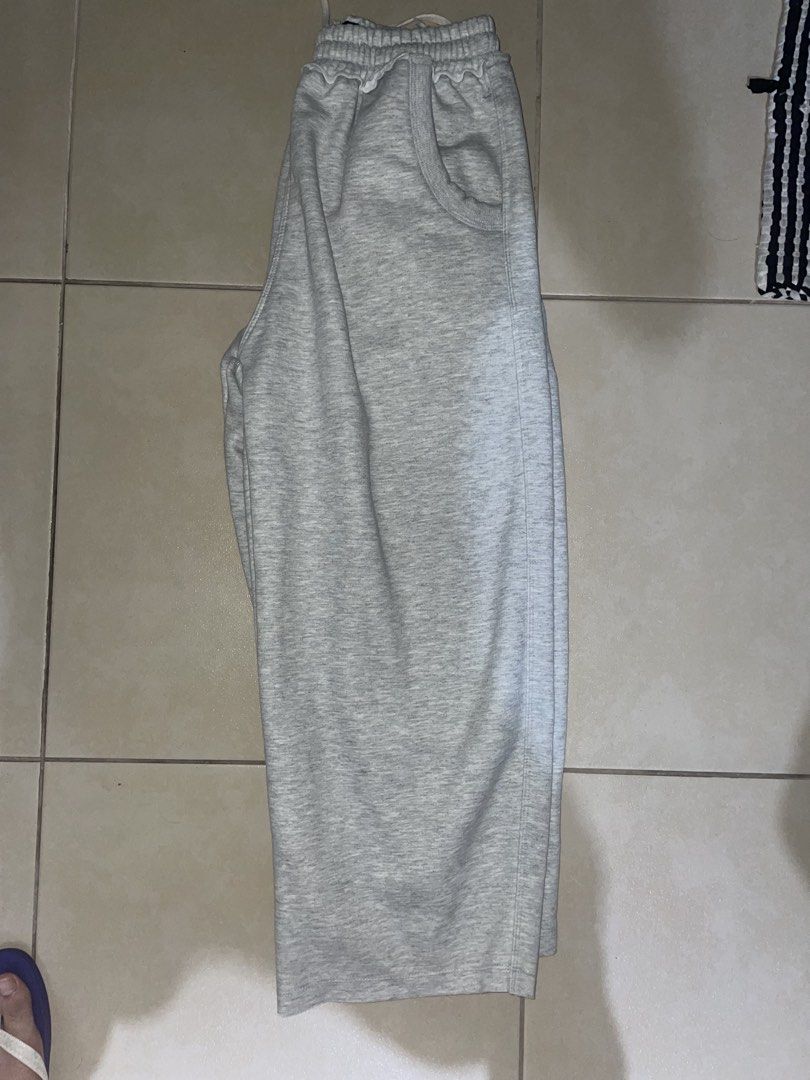 Made in MNL Grey Sweatpants -XL (Category: Joggers) located in Makati City. Submitted by oddbear_e25815 (Listing ID 1470916814, Image 3). Description: - Brand: Made in MNL -SIZE: XL - Color: Grey - Material: Soft fleece lining inside - Fit: Relaxed wide leg fit - Waistband: Elastic with a drawstring closure - Pockets: Deep front pockets - Details: Black brand tag stitched at the back waist - Condition: Clean, no stains or holes.
