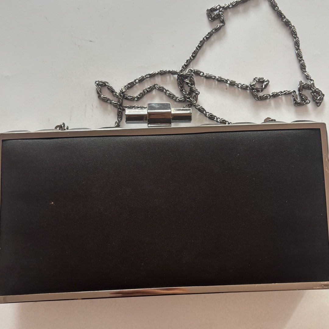Mags Black and Silver Beaded Hard Clutch Bag (Category: Clutches) located in Marilao. Submitted by pinhail (Listing ID 1470930371, Image 2). Description: - Brand: Mags - Material: Black satin with black fabric lining - Hardware & Closure: Silver metal frame with push-lock clasp - Embellishments: Clear faceted square crystals and rows of black beads - Strap: Includes a detachable gunmetal chain - Condition: Used once with original store tag attach