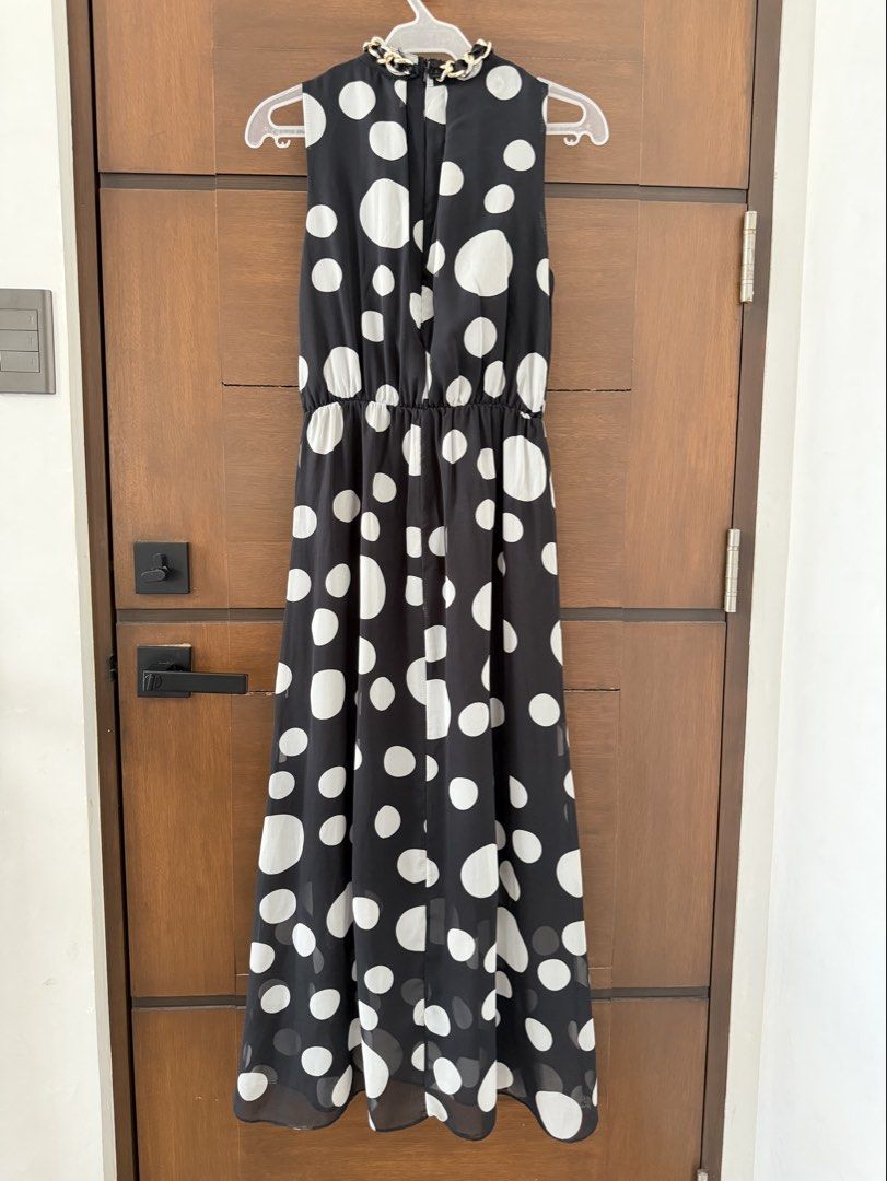 Mags Black Polka Dot Maxi Dress Size S (Category: Dresses) located in San Fernando. Submitted by lovepreloved13 (Listing ID 1470753586, Image 2). Description: - Brand: Mags - Size: Small (S) - Color/Pattern: Classic black with white polka dots - Design: Sleeveless maxi dress with built-in chain & braided fabric necklace featuring a matching front rose detail - Fit: Comfortable elasticized waist (pwede for preggies) - Closure: Convenient back zipp