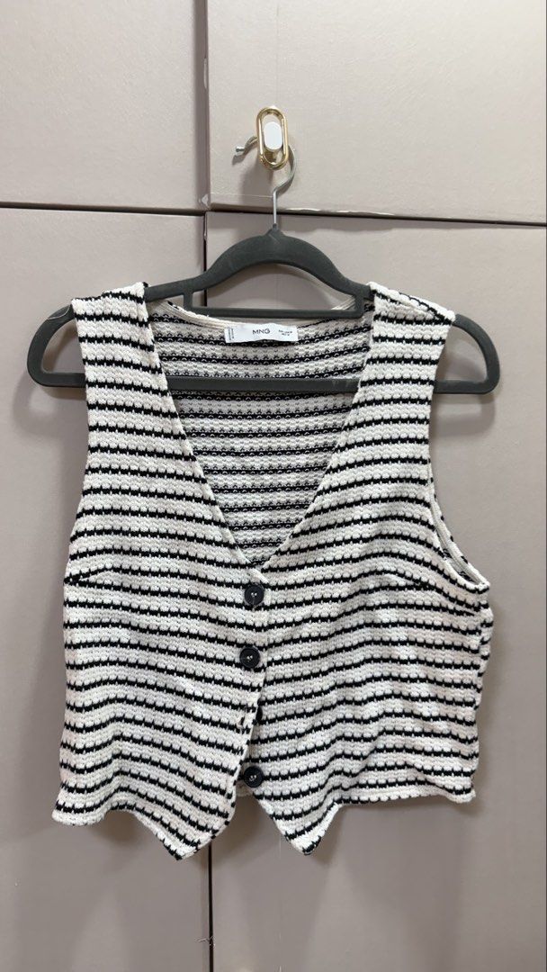Mango Black and White Striped Knitted Vest Size M (Category: Sleeveless) located in Paranaque City. Submitted by shop_tinascloset (Listing ID 1470835699, Image 1). Description: - Brand: Mango - Style: Knitted vest with black & white stripes - Details: V-neck, front button closures, cropped fit with pointed hem - Size: M (tag on collar) .