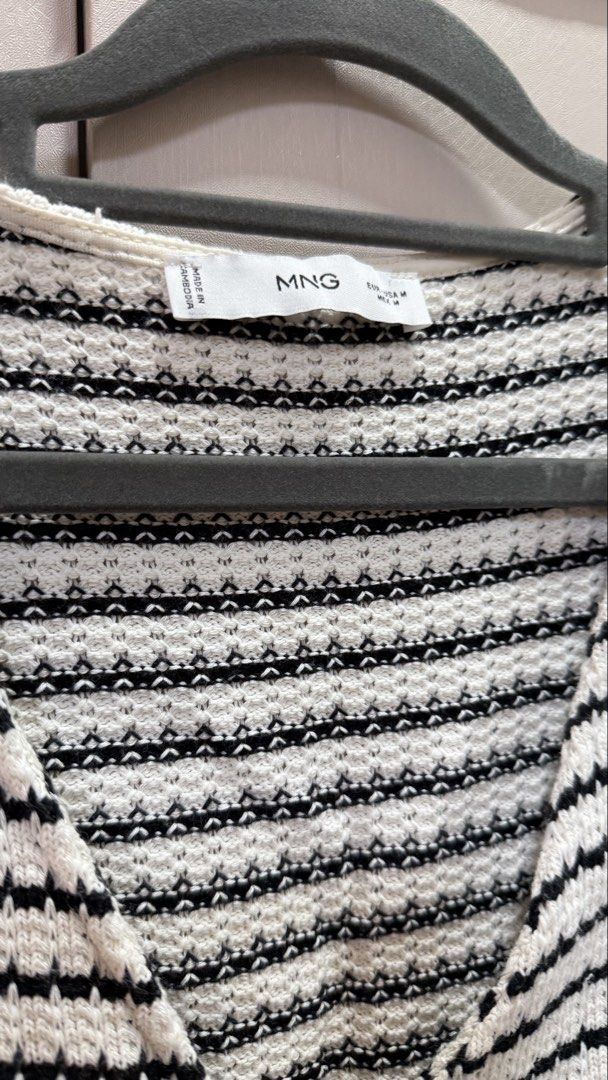 Mango Black and White Striped Knitted Vest Size M (Category: Sleeveless) located in Paranaque City. Submitted by shop_tinascloset (Listing ID 1470835699, Image 2). Description: - Brand: Mango - Style: Knitted vest with black & white stripes - Details: V-neck, front button closures, cropped fit with pointed hem - Size: M (tag on collar) .