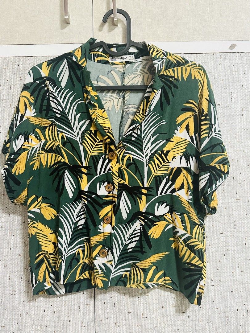 Mango Casual Tropical Leaf Print Button Up Shirt (Category: Shirts) located in Manila. Submitted by thebestre (Listing ID 1470878854, Image 1). Description: - Brand: Mango - Style: Casual button-down with camp collar and tortoiseshell buttons - Print: Bold green, yellow, and white tropical palm leaf pattern - Fit & Size: Relaxed fit, EUR XS / USA 2 - Material: Lightweight fabric, ideal for warm weather and vacations - Condition: Excellent pre-lov