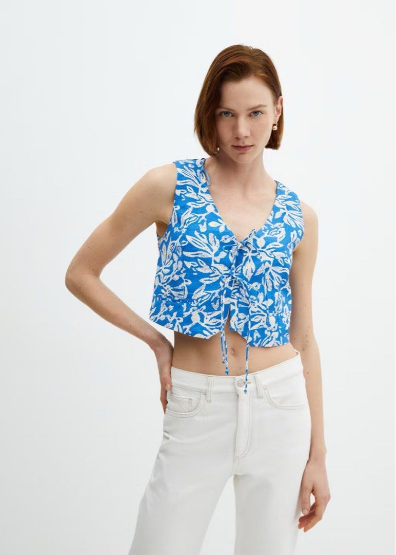 MANGO Waistcoat with Tie (Category: Sleeveless) located in Manila. Submitted by kbrxy (Listing ID 1470850275, Image 1). Description: - Brand: Mango - Size: M - Blue cropped vest with a white floral pattern.