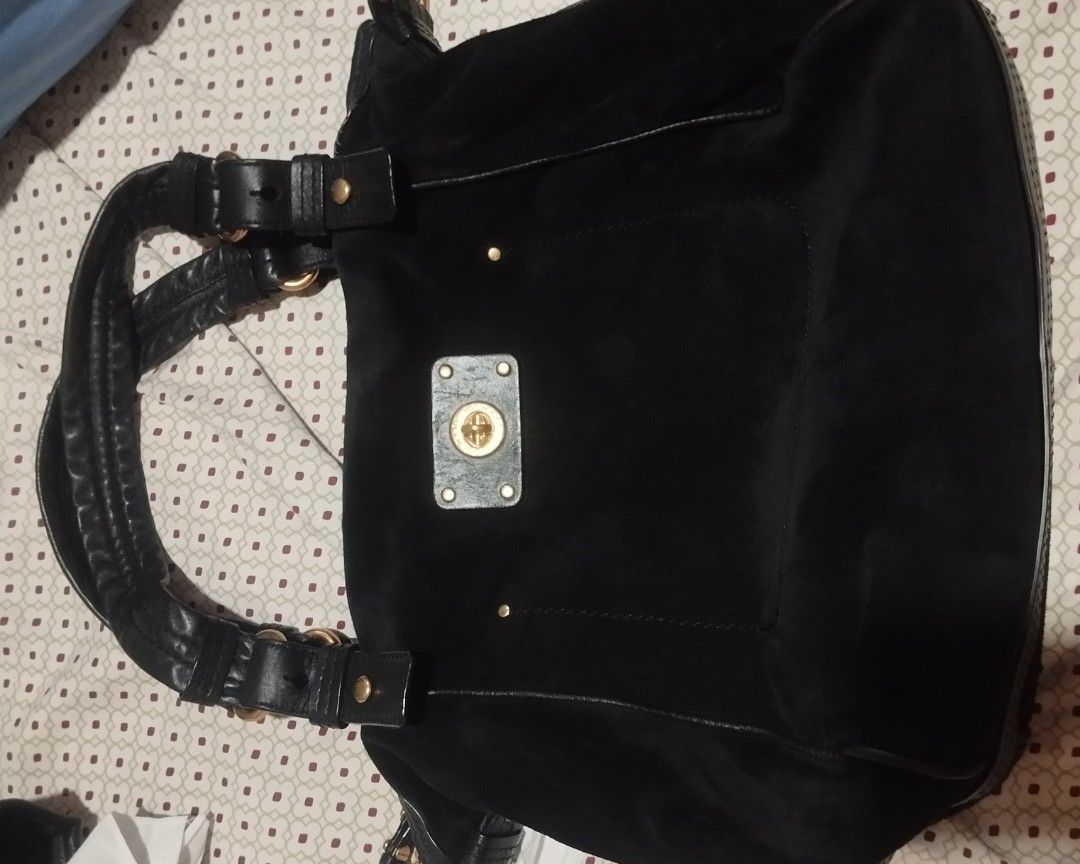 Marc by Marc Jacobs black suede handbag (Category: Cross-body Bags) located in Manila. Submitted by lene48 (Listing ID 1470852795, Image 1). Description: - Color & Material: Black suede with visible grain texture and gold-tone hardware - Pockets: Front pocket with engraved brand name turn-lock closure and a roomy main compartment - Straps: Includes structured leather handles plus an adjustable and detachable long strap with lobster clasps - Usage