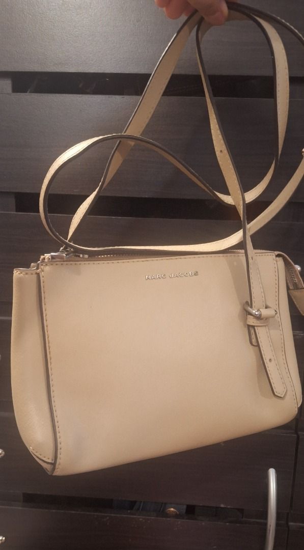 MARC JACOBS Body Bag (Category: Cross-body Bags) located in General Trias. Submitted by aeunice (Listing ID 1470805974, Image 2). Description: Brand: Marc Jacobs In Good Condition. Authentic beige leather Marc Jacobs crossbody bag with silver hardware, adjustable strap, back slip pocket and a burgundy interior with a zip pocket. A chic and versatile bag, perfect for everyday use or casual outings. Meet up / Shipping via Lalamove, JnT, Gogo Expres