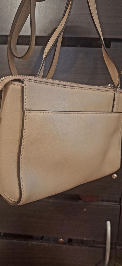 MARC JACOBS Body Bag (Category: Cross-body Bags) located in General Trias. Submitted by aeunice (Listing ID 1470805974, Image 3). Description: Brand: Marc Jacobs In Good Condition. Authentic beige leather Marc Jacobs crossbody bag with silver hardware, adjustable strap, back slip pocket and a burgundy interior with a zip pocket. A chic and versatile bag, perfect for everyday use or casual outings. Meet up / Shipping via Lalamove, JnT, Gogo Expres