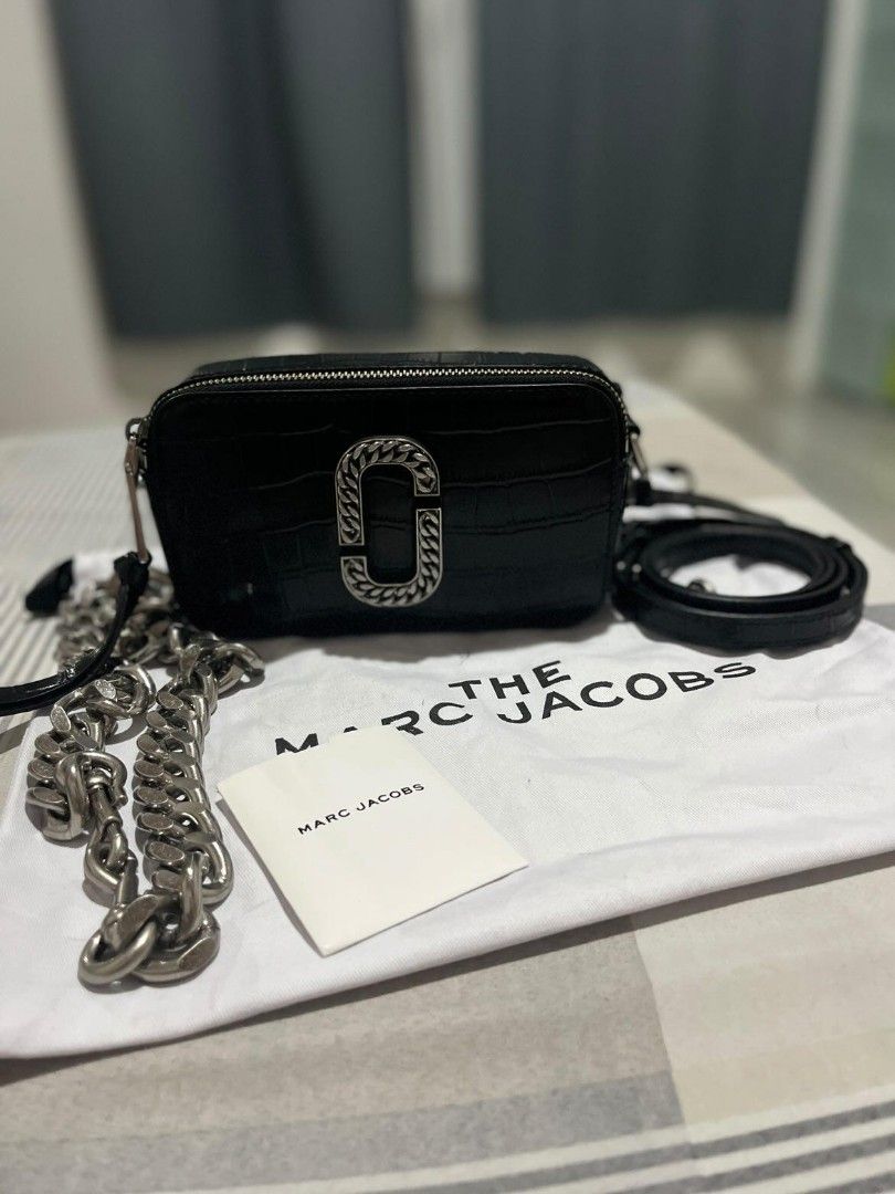 Marc Jacobs Snapshot Croc Embossed Camera Bag (Category: Luxury Bags & Wallets) located in Polomolok. Submitted by legadad94559 (Listing ID 1470809120, Image 3). Description: Marc Jacobs camera bag in black croc-embossed leather - Striking silver chain link J logo and heavy chunky silver shoulder strap - Includes an interchangeable matching black leather strap - Practical dual zipped compartments with a super clean interior and exterior. w/ care 