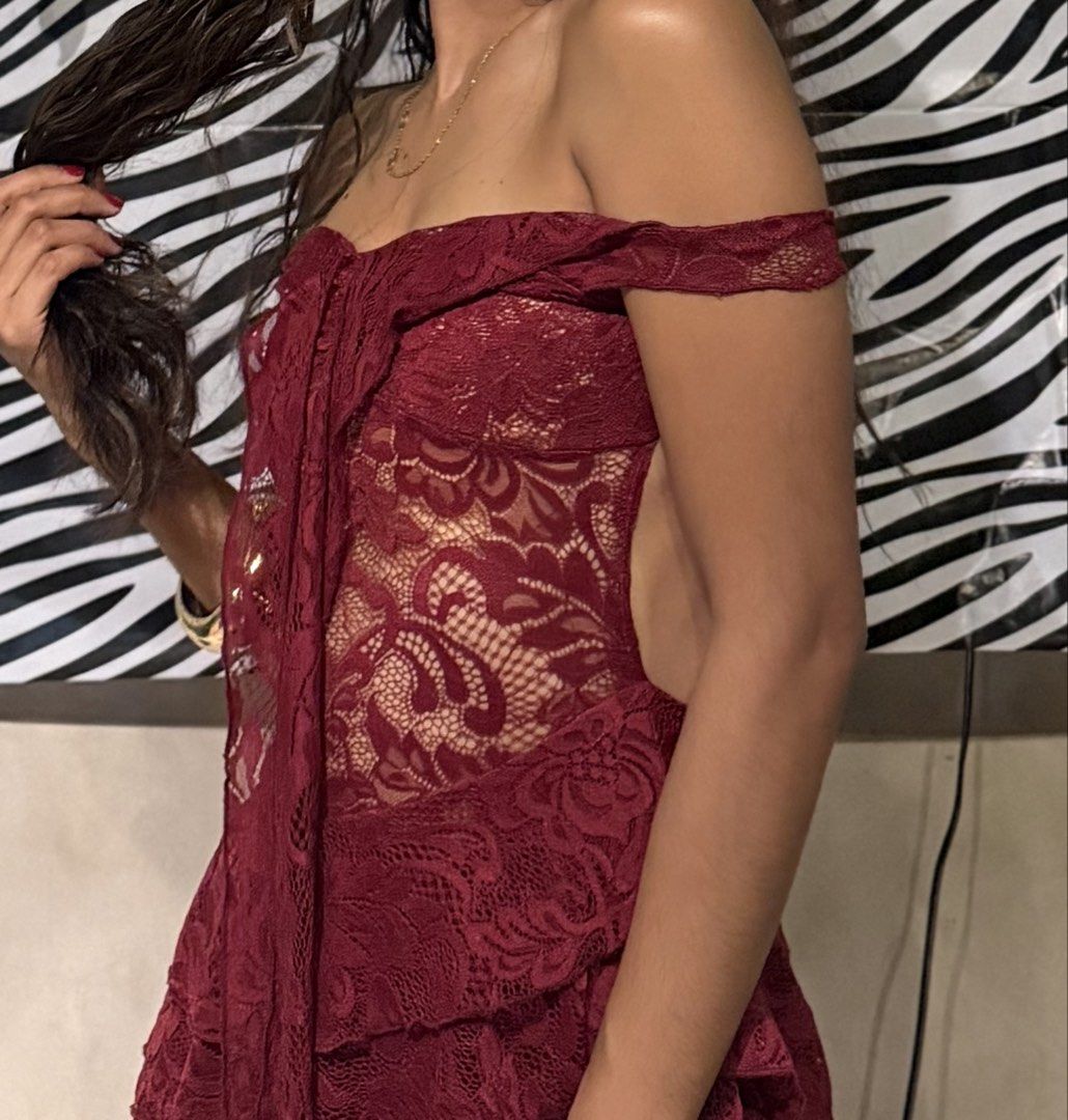 Maroon lace off-shoulder high-low dress (Category: Dresses) located in Manila. Submitted by carollous (Listing ID 1470875717, Image 3). Description: - Color: Deep maroon - Style: Off-shoulder lace dress with short sleeves and back zip closure - Design: Elegant high-low hemline with layered ruffles and semi-sheer patterned panels - Condition: Worn once for a birthday dinner, freshly dry cleaned and ready to wear - Ideal for: Parties, dinner dates,