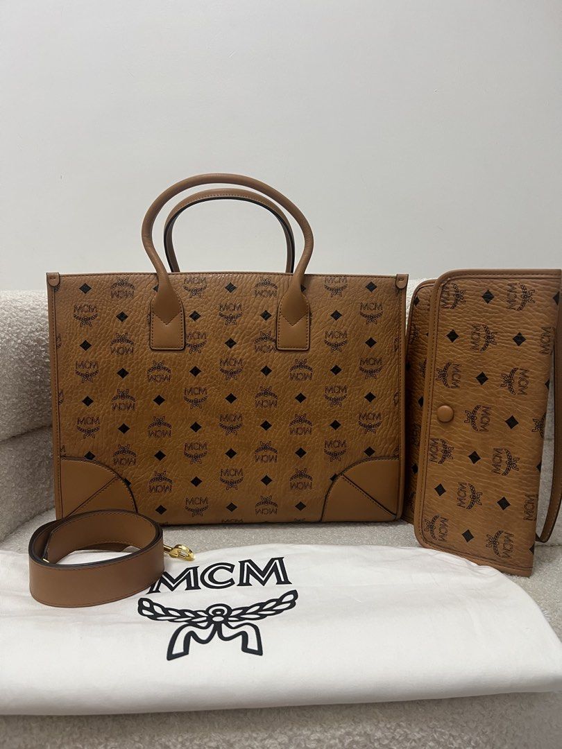 MCM Cognac Visetos Monogram Tote Bag with Pouch (Category: Tote Bags) located in Abulug. Submitted by jamiecammie (Listing ID 1470820909, Image 1). Description: - Authentic MCM structured tote bag in classic cognac Visetos monogram - Crafted with durable pebble-textured leather and dark brown trim - Includes dual top handles and a detachable, adjustable shoulder strap - Comes with a matching wallet/pouch and the original dust bag - Features premi