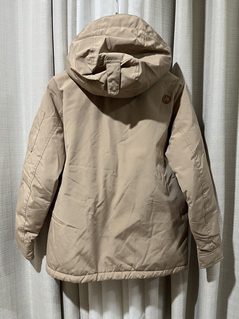 Men Marmot Down Winter Parka Jacket Khaki Beige Size 90 (23” x 27”) (Category: Coats, Jackets and Outerwear) located in Tarlac. Submitted by thriftygoodss (Listing ID 1470928279, Image 2). Description: - Brand: Marmot - Color: Khaki Beige with Glossy Brown Interior - Style: Down Puffer / Hooded Parka - Closure: Front zipper and button closure - Pockets: Multiple functional pockets on front and sleeve - Branding: Embroidered Marmot logo on chest, 