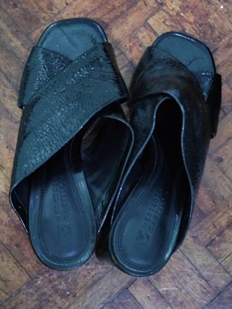 Mercedes Castillo Black Mules (Category: Flats & Sandals) located in Bacoor. Submitted by stargazer1084 (Listing ID 1470836374, Image 2). Description: - Brand: Mercedes Castillo - Style: Slip-on mules with chic square open toe - Design: Criss-cross textured straps across the top - Heel: Comfortable chunky block heel, easy to dress up or down - Comfort: Cushioned footbed with stamped logo for all-day wear - Versatility: Perfect for both work outfi