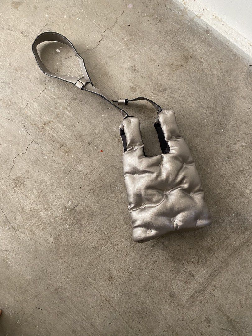 Metallic silver puffer tote shoulder bag (Category: Tote Bags) located in Quezon City. Submitted by yurii694 (Listing ID 1470784030, Image 2). Description: - Color/Finish: Metallic silver with a trendy pillowy aesthetic - Material: Quilted padding texture - Versatile Carry: Includes double top handles and an adjustable long strap for crossbody wear - Size: Medium, fits all your daily essentials easily (phone, makeup, etc.) .