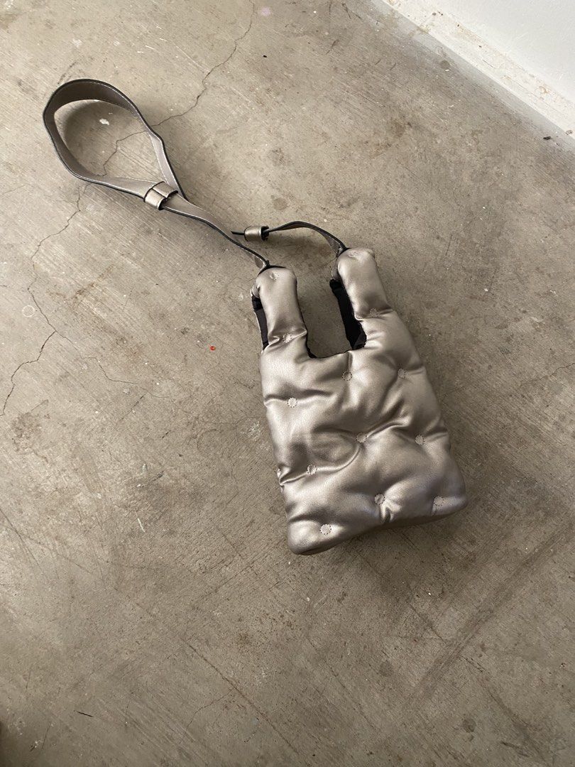 Metallic silver puffer tote shoulder bag (Category: Tote Bags) located in Quezon City. Submitted by yurii694 (Listing ID 1470784030, Image 1). Description: - Color/Finish: Metallic silver with a trendy pillowy aesthetic - Material: Quilted padding texture - Versatile Carry: Includes double top handles and an adjustable long strap for crossbody wear - Size: Medium, fits all your daily essentials easily (phone, makeup, etc.) .