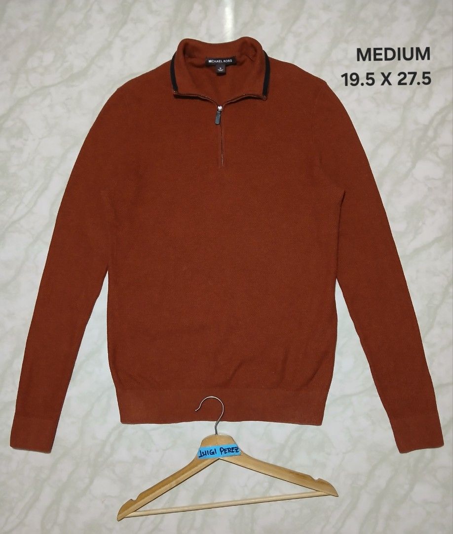 Michael Kors 1/4 Zip Rust Knit Sweater Medium (Category: Coats, Jackets and Outerwear) located in Plaridel. Submitted by igieperez147282 (Listing ID 1470831187, Image 2). Description: - Brand: Michael Kors - Style: Quarter zip sweater - Color: Rust orange with black piping on the collar - Size: Medium - Measurements (Flat Lay): 19.5" chest width x 27.5" length - Material: Soft textured knit - Condition: Excellent, clean inside tags and care label