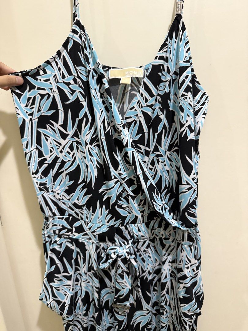 Michael Kors Blue Black Leaf Print Jumpsuit Size M (Category: Jumpsuits) located in Taguig. Submitted by preloved.by.diane (Listing ID 1470874754, Image 3). Description: - Brand: Michael Kors - Size: M - Color/Pattern: Blue, black, and white leaf print - Style: Sleeveless V-neck wrap top with tie belt - Features: Branded metal hardware details on straps - Origin: Made in Vietnam - Condition: Excellent/Worn with care - Perfect for: Casual outings,