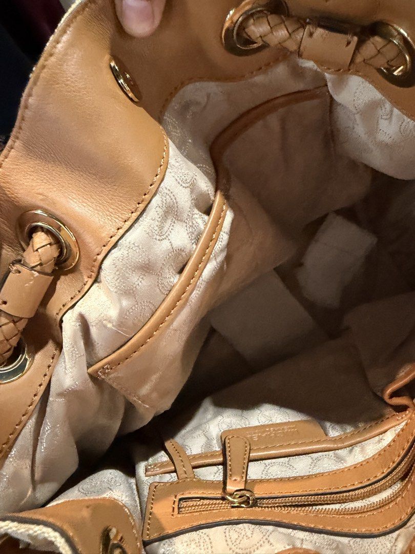 Michael Kors Jet Set LG Gathered Tote (Category: Tote Bags) located in Malabon City. Submitted by LunaAdrienne (Listing ID 1470788569, Image 2). Description: - Brand: Michael Kors - Style: Jet Set Large Gathered Tote - Color/Pattern: Beige and gold MK signature monogram fabric with tan leather trim - Handles: Stylish braided handles with original tissue paper attached - Closure: Drawstring top - Hardware: Gold-tone hardware with signature MK logo