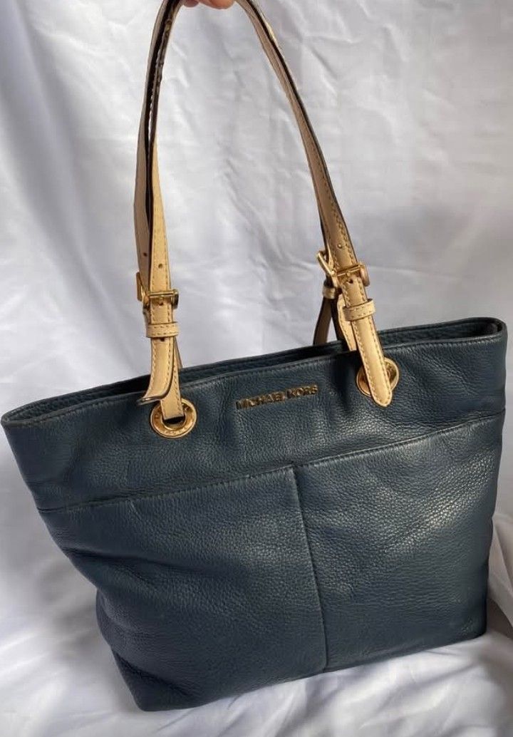 Michael Kors Navy Blue Leather Tote Bag (Category: Tote Bags) located in Manila. Submitted by zenbear_6b2d8a (Listing ID 1470755514, Image 1). Description: - Brand: Michael Kors - Color: Dark blue pebbled leather with tan straps - Hardware: Gold-tone with gold logo lettering - Pockets: Dual front exterior pockets for easy access - Interior: Spacious and practical for everyday use - Condition: Excellent, well-maintained - Mode of Payment: BPI / GC