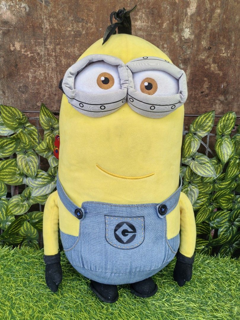 Minion Plush Toy Despicable Me 3 (Category: Plushies & Soft Toys) located in Paranaque City. Submitted by furugiyafinds (Listing ID 1470797241, Image 1). Description: - Official Despicable Me 3 Minion stuffed toy - Tall yellow plush design with embroidered facial details - Comes with classic fabric overalls, black gloves, and shoes - Clean and well-maintained fabric - Official branding tag attached at the back.
