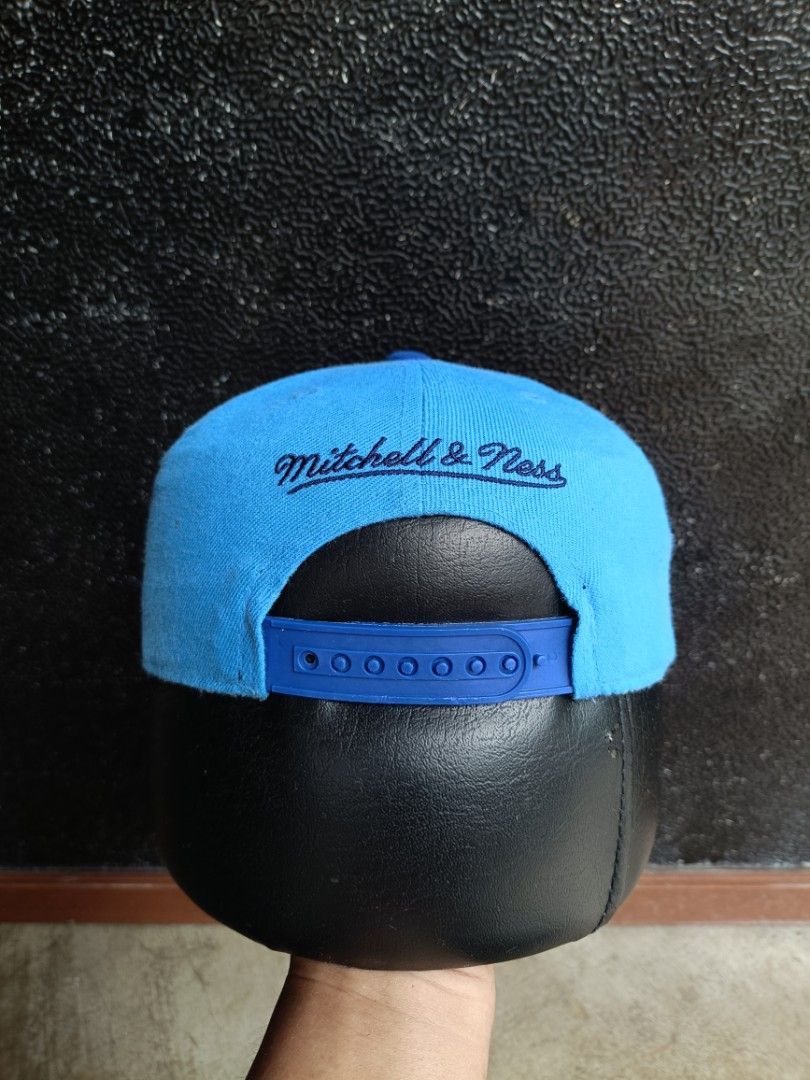 Mitchell & Ness Los Angeles Lakers Snapback Cap Blue (Category: Caps & Hats) located in Daet. Submitted by quickearth.ac7e7e (Listing ID 1470791479, Image 3). Description: - Brand: Mitchell & Ness - Style: Snapback hat with flat brim - Color: Bright blue with dark blue accents - Embroidery: 'Los Angeles' script on front, Lakers text and star graphics on the side - Closure: Adjustable blue plastic snapback - Condition: Clean structure with neat st