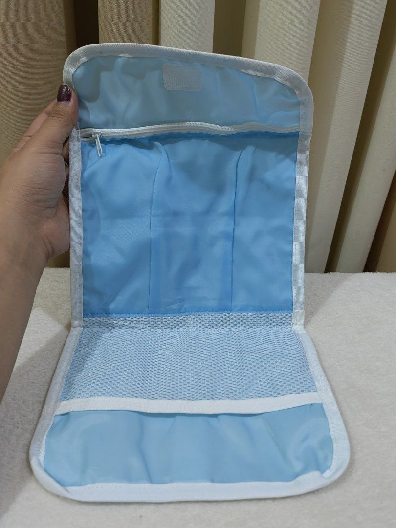 Mitsukoshi Light Blue Foldable Travel Organizer Toiletry Pouch (Category: Purses & Pouches) located in Makati City. Submitted by prelovedtreatedwithlove (Listing ID 1470896668, Image 2). Description: - Brand/Model: Authentic Mitsukoshi foldable travel pouch - Color: Light blue with a stylish fashion illustration print of a woman walking on the back - Closure: Front flap with secure velcro closure - Versatile Use: Compact size great for organizing
