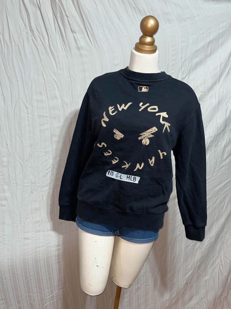 MLB New York Yankees Black Sweatshirt (Category: Coats, Jackets and Outerwear) located in General Trias. Submitted by crissy9053136 (Listing ID 1470761291, Image 2). Description: - Color: Classic Black - Brand/Team: Official MLB New York Yankees - Design: Small embroidered NY logo on left chest with a larger front graphic print and baseball bat details - Features: Round neckline, ribbed cuffs, and hem - Size: Labeled S to L - Condition: Great ove