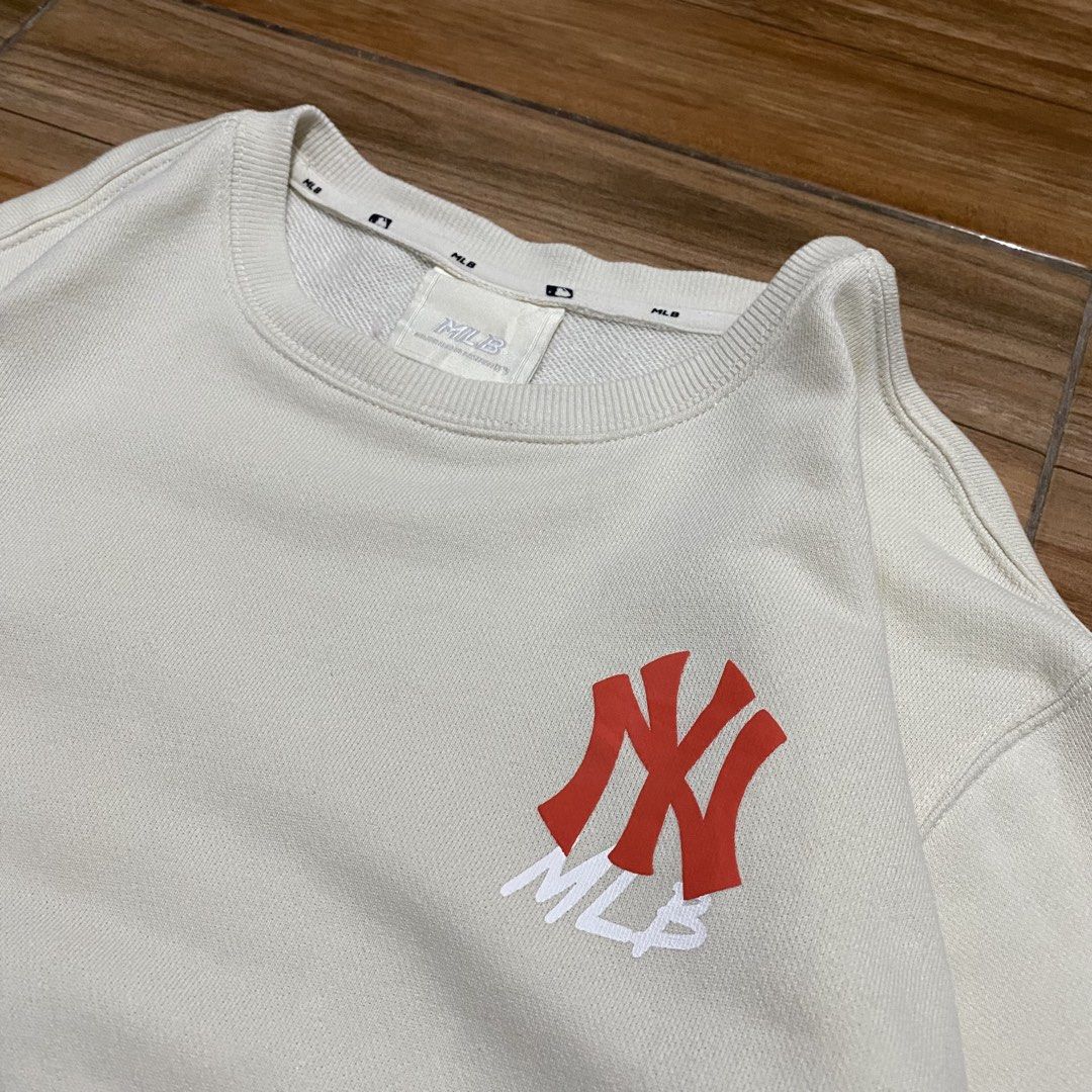 MLB New York Yankees Sweatshirt Cream (Category: Coats, Jackets and Outerwear) located in Baguio. Submitted by arenzu (Listing ID 1470845646, Image 3). Description: - Authentic MLB New York Yankees merchandise - Color: Cream with red accents - Design: Small red NY logo on front chest, big red New York Yankees print on the back - Style: Classic crew neck with ribbed cuffs and hem - Material: Soft, comfortable fabric - Condition: Excellent pre-love