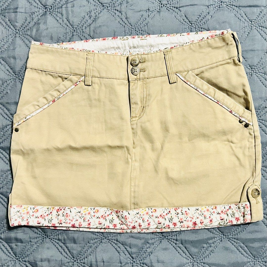 MNG Basic Style Khaki Floral Trim Cargo Skirt (Category: Skirts) located in Quezon City. Submitted by halfofit (Listing ID 1470746817, Image 1). Description: - Brand: MNG New Basic Style - Color: Khaki with floral fabric trim - Size: EUR 34 / USA 2 - Closure: Double button with zip fly - Pockets: Front slant pockets and back buttoned flap pockets - Extras: Includes belt loops - Condition: Great casual piece.