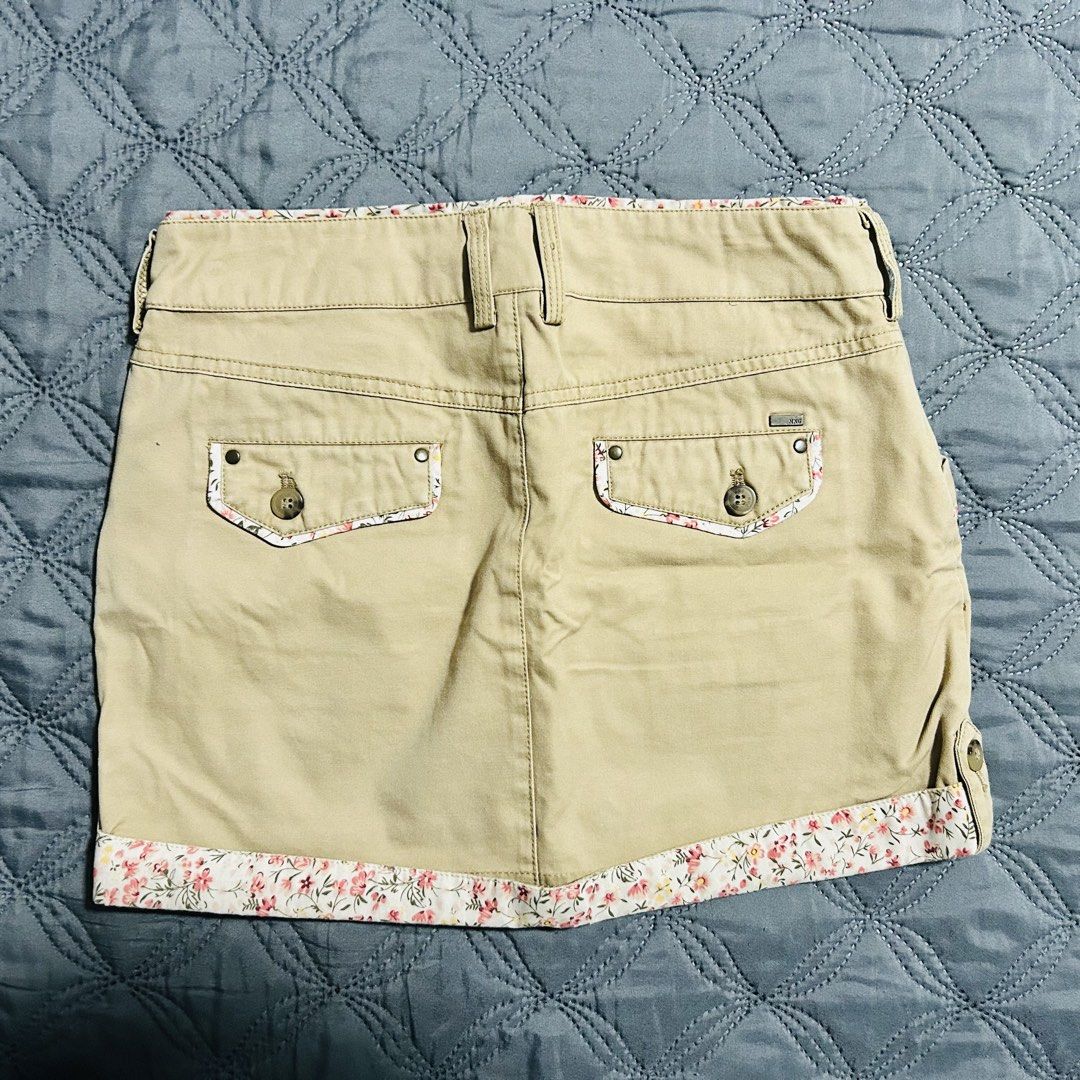 MNG Basic Style Khaki Floral Trim Cargo Skirt (Category: Skirts) located in Quezon City. Submitted by halfofit (Listing ID 1470746817, Image 2). Description: - Brand: MNG New Basic Style - Color: Khaki with floral fabric trim - Size: EUR 34 / USA 2 - Closure: Double button with zip fly - Pockets: Front slant pockets and back buttoned flap pockets - Extras: Includes belt loops - Condition: Great casual piece.