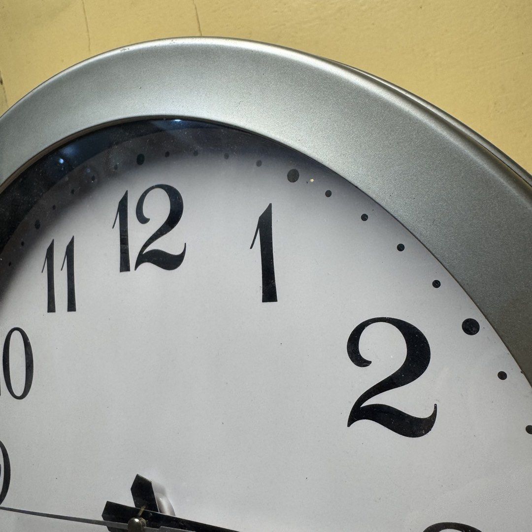 Modern Metallic Silver Wall Clock (Model E-HN101S) (Category: Clocks) located in Pasig City. Submitted by msjazzylad (Listing ID 1470929293, Image 2). Description: Product Overview Style: Modern Minimalist Round Wall Clock Color & Finish: Metallic Silver / Satin Gray Frame with clean off-white dial at bold serif-style numbers Movement / Engine: Sang Tai 7168S Quartz Movement Dimensions: Approx. 11.5 inches (29 cm) diameter Power: 1x AA Battery op