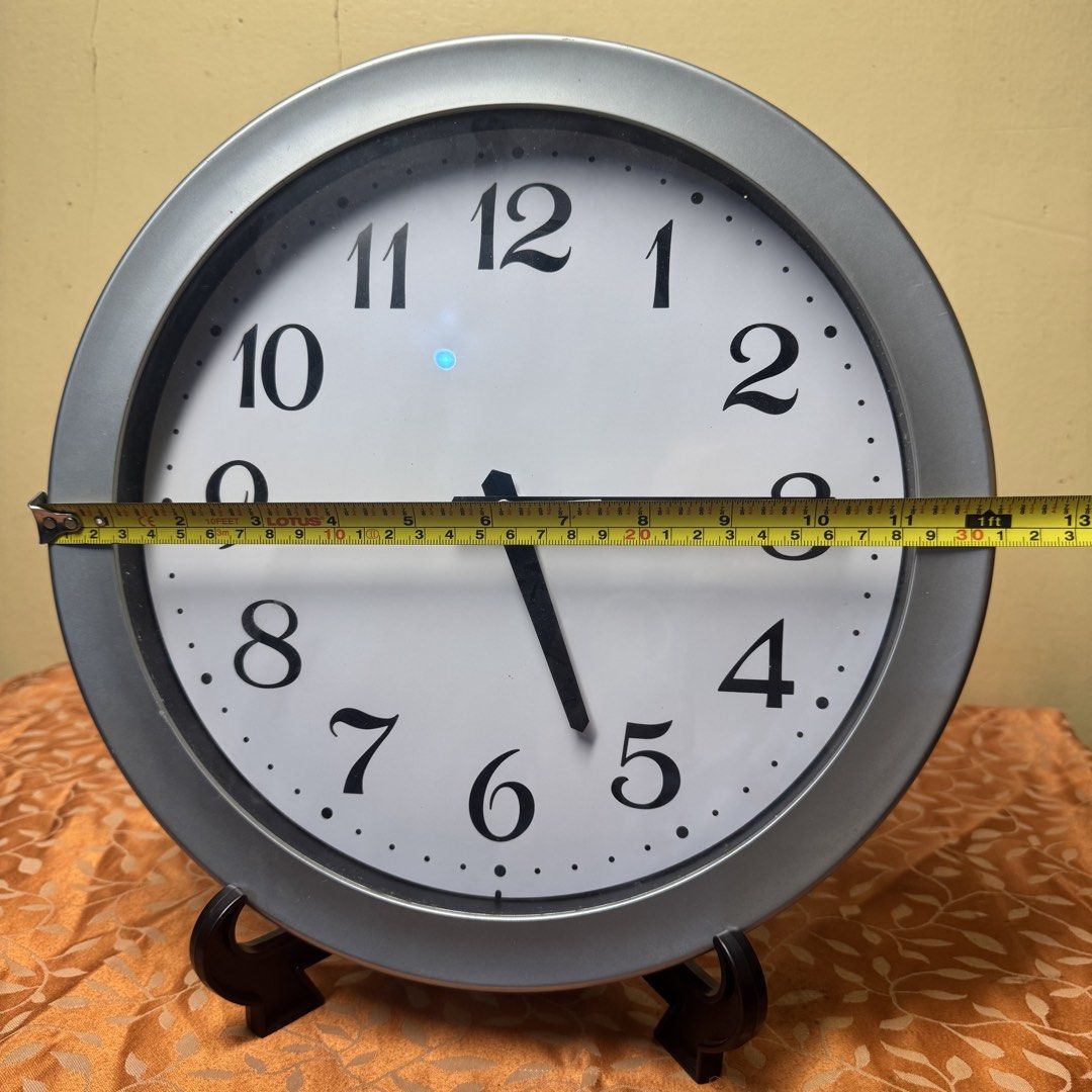 Modern Metallic Silver Wall Clock (Model E-HN101S) (Category: Clocks) located in Pasig City. Submitted by msjazzylad (Listing ID 1470929293, Image 3). Description: Product Overview Style: Modern Minimalist Round Wall Clock Color & Finish: Metallic Silver / Satin Gray Frame with clean off-white dial at bold serif-style numbers Movement / Engine: Sang Tai 7168S Quartz Movement Dimensions: Approx. 11.5 inches (29 cm) diameter Power: 1x AA Battery op