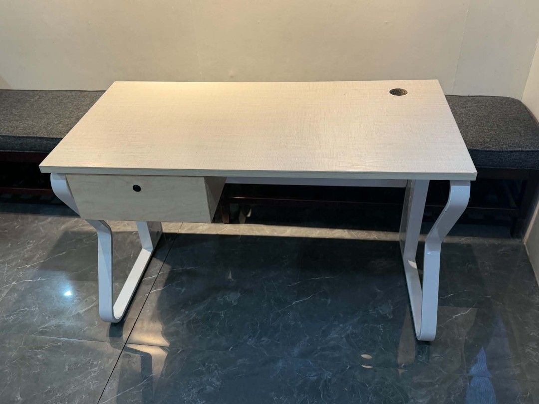 Modern study desk with white metal frame and drawer (Category: Office Furniture & Fixtures) located in Quezon City. Submitted by kcofficefurnitures (Listing ID 1470828441, Image 1). Description: OFFICE TABLE WITH DRAWER – LIGHT WOOD FINISH Upgrade your workspace with this stylish and functional office table, perfect for offices, home offices, and study areas. Product Details: Design: Modern minimalist Color: Light wood finish with white metal leg