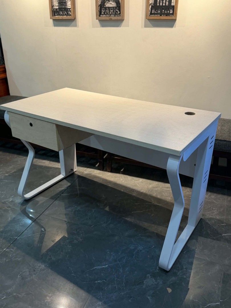 Modern study desk with white metal frame and drawer (Category: Office Furniture & Fixtures) located in Quezon City. Submitted by kcofficefurnitures (Listing ID 1470828441, Image 2). Description: OFFICE TABLE WITH DRAWER – LIGHT WOOD FINISH Upgrade your workspace with this stylish and functional office table, perfect for offices, home offices, and study areas. Product Details: Design: Modern minimalist Color: Light wood finish with white metal leg