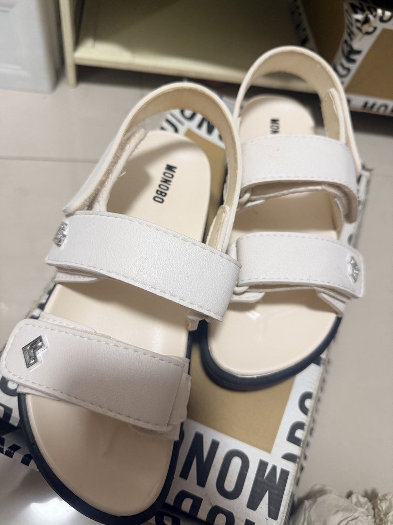 Monobo White Sandals with Box (Category: Flats & Sandals) located in Marikina City. Submitted by ukayshopping (Listing ID 1470823770, Image 1). Description: - Brand: Monobo - Color: White - Style: Casual platform sandals with easy slip-on design - Closure: Adjustable double straps with secure Velcro - Sole: Chunky grooved rubber sole for reliable grip - Details: Stylish metal hardware and clean footbed with printed logo - Inclusions: Comes with o