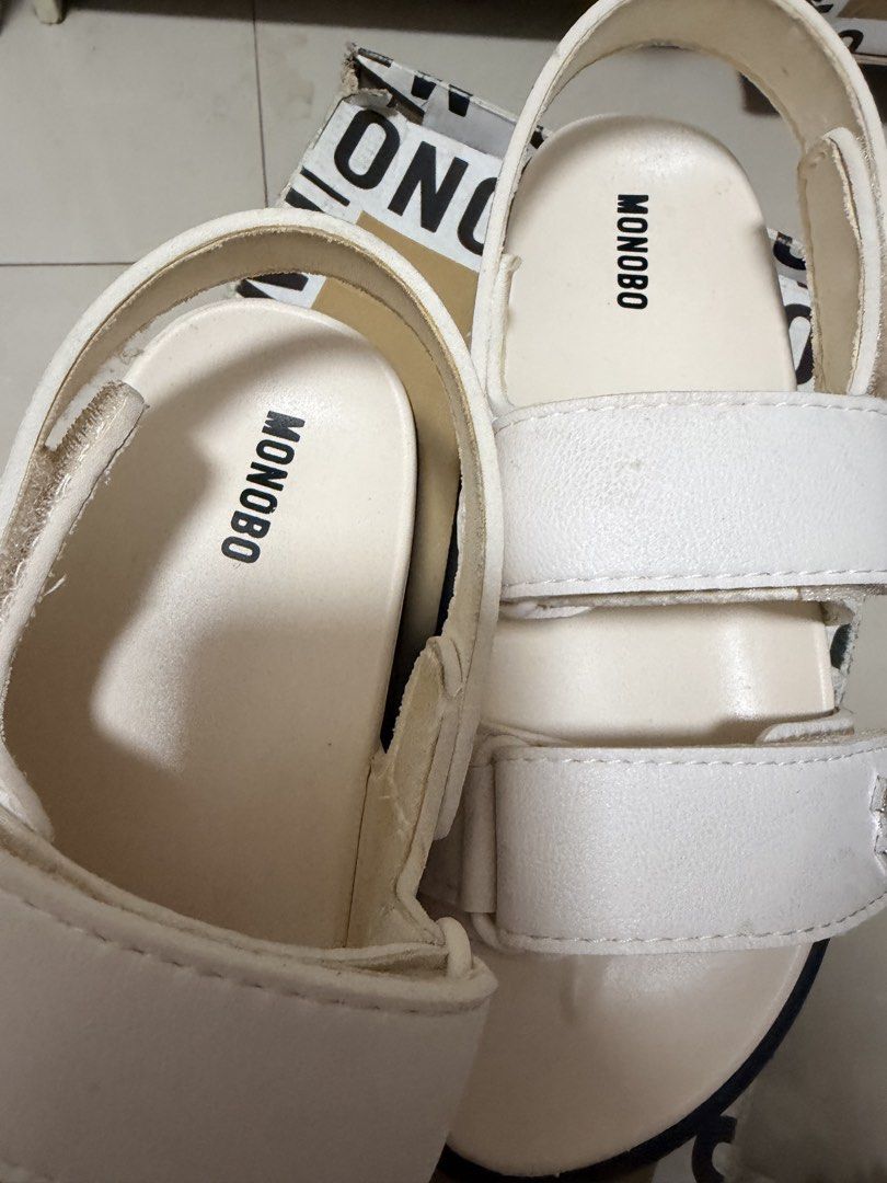 Monobo White Sandals with Box (Category: Flats & Sandals) located in Marikina City. Submitted by ukayshopping (Listing ID 1470823770, Image 2). Description: - Brand: Monobo - Color: White - Style: Casual platform sandals with easy slip-on design - Closure: Adjustable double straps with secure Velcro - Sole: Chunky grooved rubber sole for reliable grip - Details: Stylish metal hardware and clean footbed with printed logo - Inclusions: Comes with o