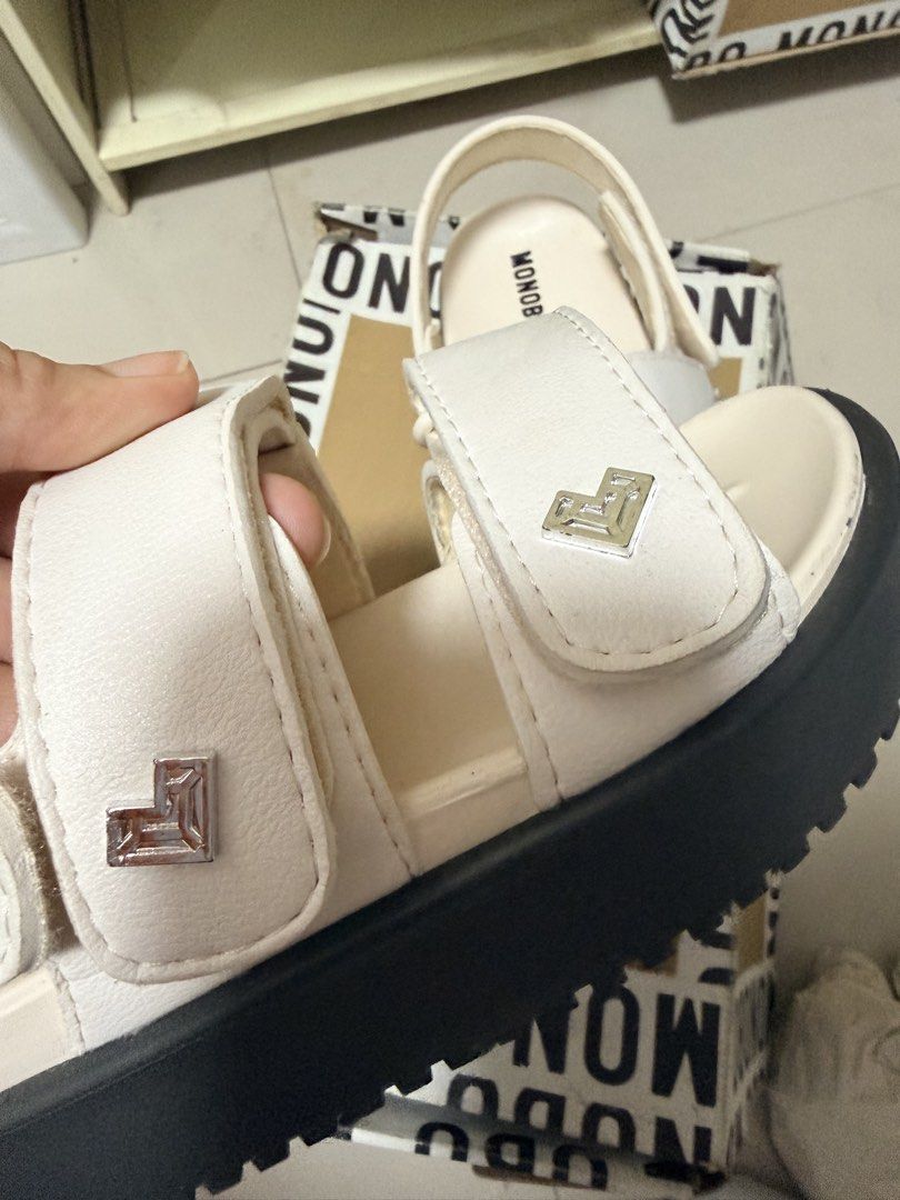 Monobo White Sandals with Box (Category: Flats & Sandals) located in Marikina City. Submitted by ukayshopping (Listing ID 1470823770, Image 3). Description: - Brand: Monobo - Color: White - Style: Casual platform sandals with easy slip-on design - Closure: Adjustable double straps with secure Velcro - Sole: Chunky grooved rubber sole for reliable grip - Details: Stylish metal hardware and clean footbed with printed logo - Inclusions: Comes with o