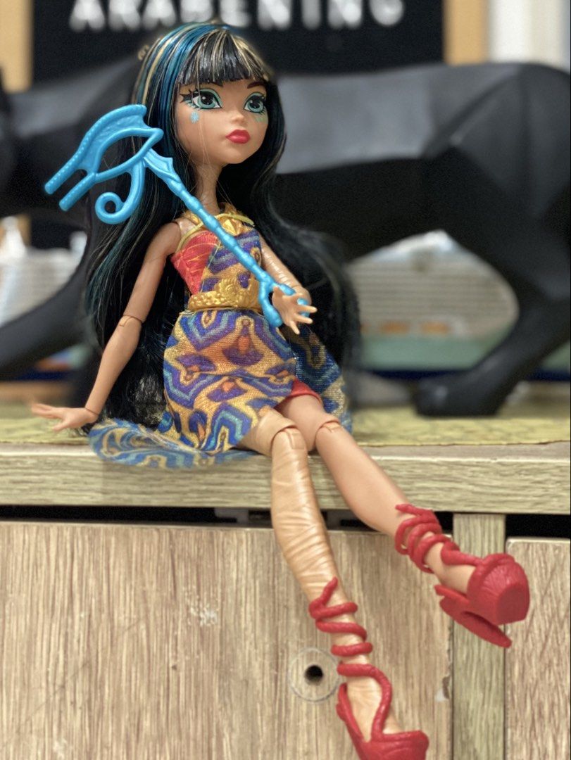 Monster High Cleo De Nile Doll with Accessories (Category: Kids Toys) located in Manila. Submitted by deniseeverafter (Listing ID 1470774284, Image 2). Description: -Complete -Clean -Features her signature long black and blue-streaked hair, patterned gold-detail dress, red wrap heels, and blue eye-symbol staff. Clean and ready to display..
