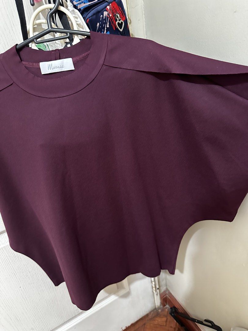 Mosaic Burgundy Batwing Sleeve Blouse (Category: Blouses) located in Balanga. Submitted by jamilbeauty5 (Listing ID 1470751950, Image 2). Description: - Brand: Mosaic - Color: Rich Burgundy - Fit: Relaxed, oversized with wide draped batwing sleeves - Design: Round neckline with chic layered shoulder flap details - Care Instructions: Hand wash cold gently, do not bleach, dry flat in the shade, low iron if needed (wash dark colors separately) - BRa