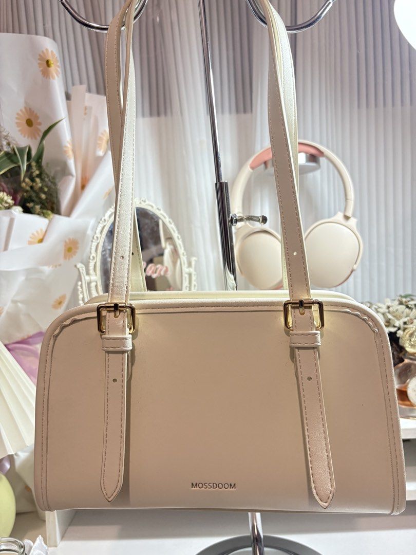 Mossdoom Cream Shoulder Bag (Category: Shoulder Bags) located in Santo Tomas. Submitted by skyy14 (Listing ID 1470863205, Image 1). Description: - Brand: Mossdoom - Color: Neutral cream (goes with everything) - Design: Clean structured shape with gold-tone buckle details - Straps: Convenient double shoulder straps that fit nicely under the arm - Closure: Secure zip top closure - Perfect for daily use and effortless styling.