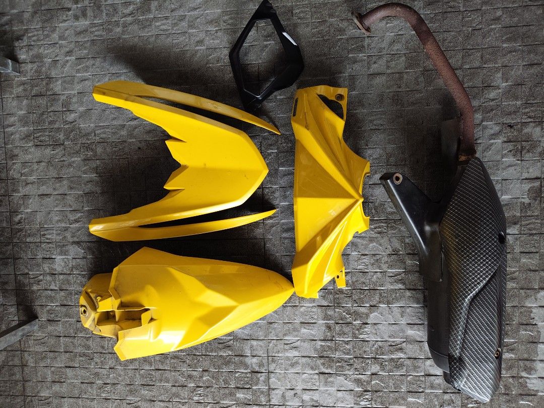Motorcycle Fairings Set and Exhaust Pipe (Category: Body Parts and Accessories) located in Pasig City. Submitted by shane0315 (Listing ID 1470750789, Image 2). Description: - Complete scooter upgrade bundle - Includes yellow body panels, front fender, and headlight bezel - Comes with stock exhaust pipe, carbon fiber style heat shield, and header pipe - Sold as a full set only - Pickup preferred due to item size - PM for inquiries and location.