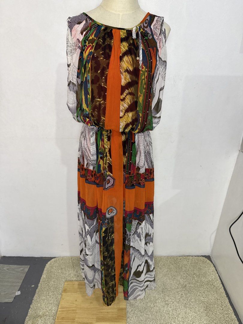 Multicolor Patchwork Print Sleeveless Midi Dress (Category: Dresses) located in Quezon City. Submitted by dropdeadprices (Listing ID 1470865124, Image 1). Description: - Vibrant sleeveless maxi dress with a unique mix of animal prints, mountain graphics, and paisley patterns - Eye-catching bright orange central panel running down the front and back - Comfortable elasticized waist for an easy fit and cinched silhouette - Lightweight, flowy fabric 