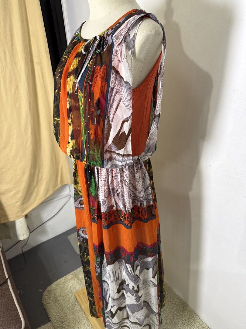Multicolor Patchwork Print Sleeveless Midi Dress (Category: Dresses) located in Quezon City. Submitted by dropdeadprices (Listing ID 1470865124, Image 2). Description: - Vibrant sleeveless maxi dress with a unique mix of animal prints, mountain graphics, and paisley patterns - Eye-catching bright orange central panel running down the front and back - Comfortable elasticized waist for an easy fit and cinched silhouette - Lightweight, flowy fabric 