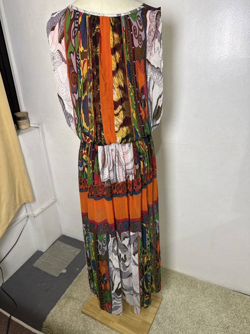 Multicolor Patchwork Print Sleeveless Midi Dress (Category: Dresses) located in Quezon City. Submitted by dropdeadprices (Listing ID 1470865124, Image 3). Description: - Vibrant sleeveless maxi dress with a unique mix of animal prints, mountain graphics, and paisley patterns - Eye-catching bright orange central panel running down the front and back - Comfortable elasticized waist for an easy fit and cinched silhouette - Lightweight, flowy fabric 