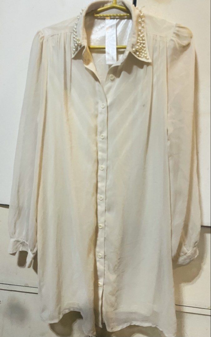 MURUA Cream Pearl Collar Long Sleeve Button Down Blouse (Category: Blouses) located in Bulacan. Submitted by grazcloset (Listing ID 1470838086, Image 1). Description: - Brand: MURUA - Color: Cream - Style: Long-sleeve button-down blouse with a classic collar - Detail: Elegant pearl embellishments along the collar and gathered shoulder details - Fabric: Lightweight with a subtle sheen - Versatility: Great for smart-casual looks or dressing up.